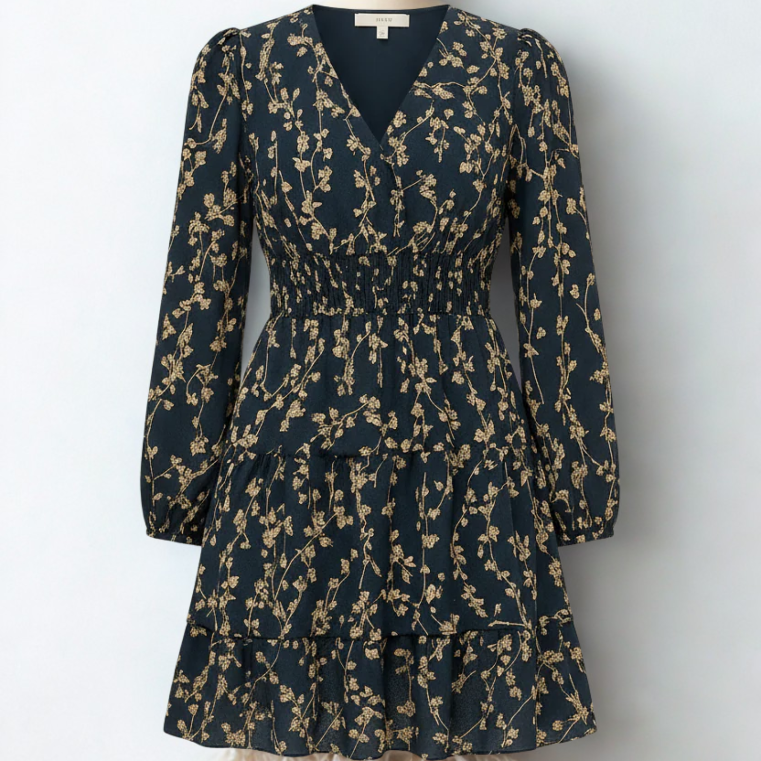 Dress with small beige flowers, featuring ruffles and gathers.