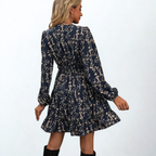 Dress with small beige flowers, featuring ruffles and gathers.