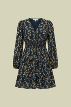 Dress with small beige flowers, featuring ruffles and gathers.