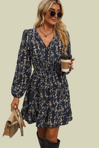 Dress with small beige flowers, featuring ruffles and gathers.