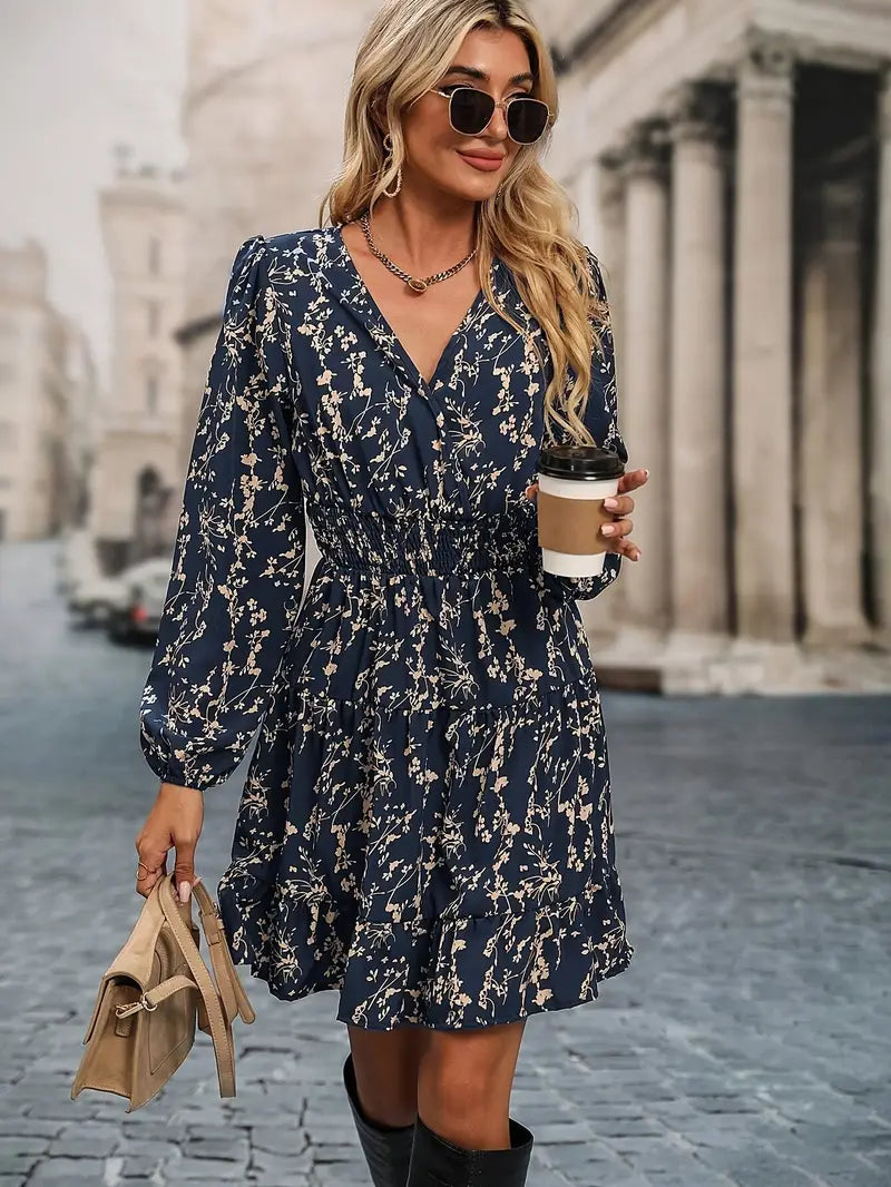 Dress with small beige flowers, featuring ruffles and gathers.