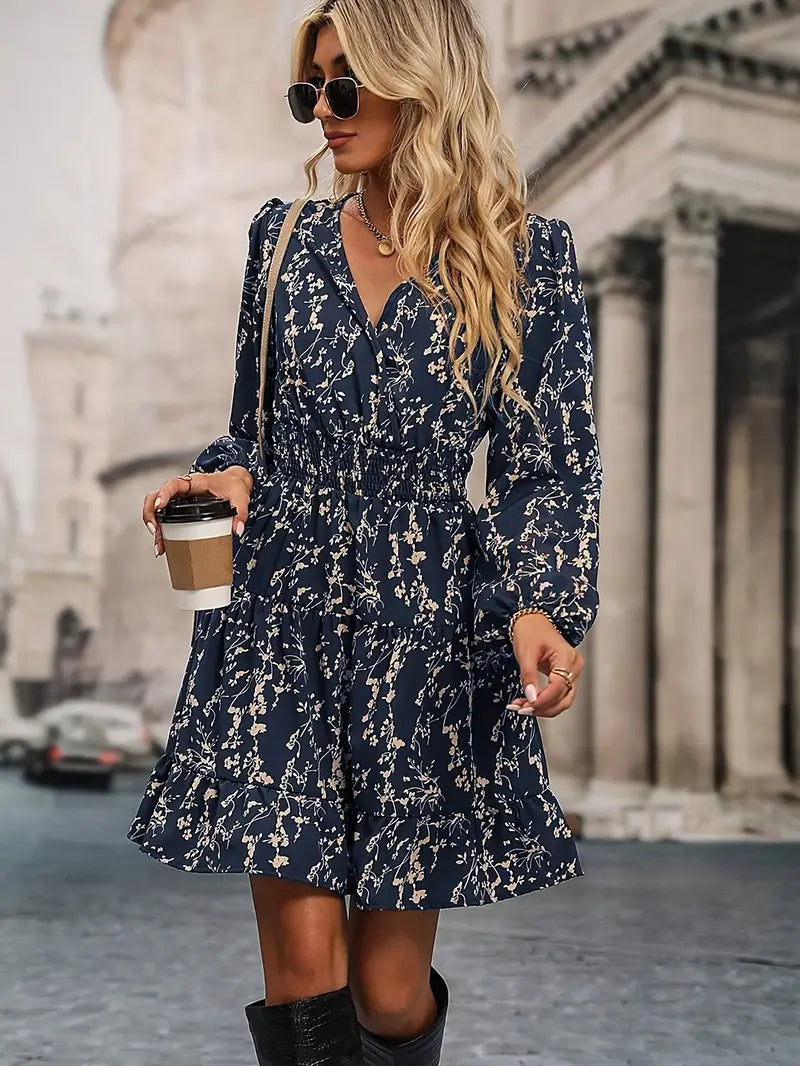 Dress with small beige flowers, featuring ruffles and gathers.